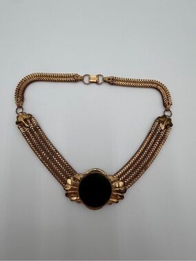 Vintage prominent green cabochon stone set within a gold-tone mesh strap